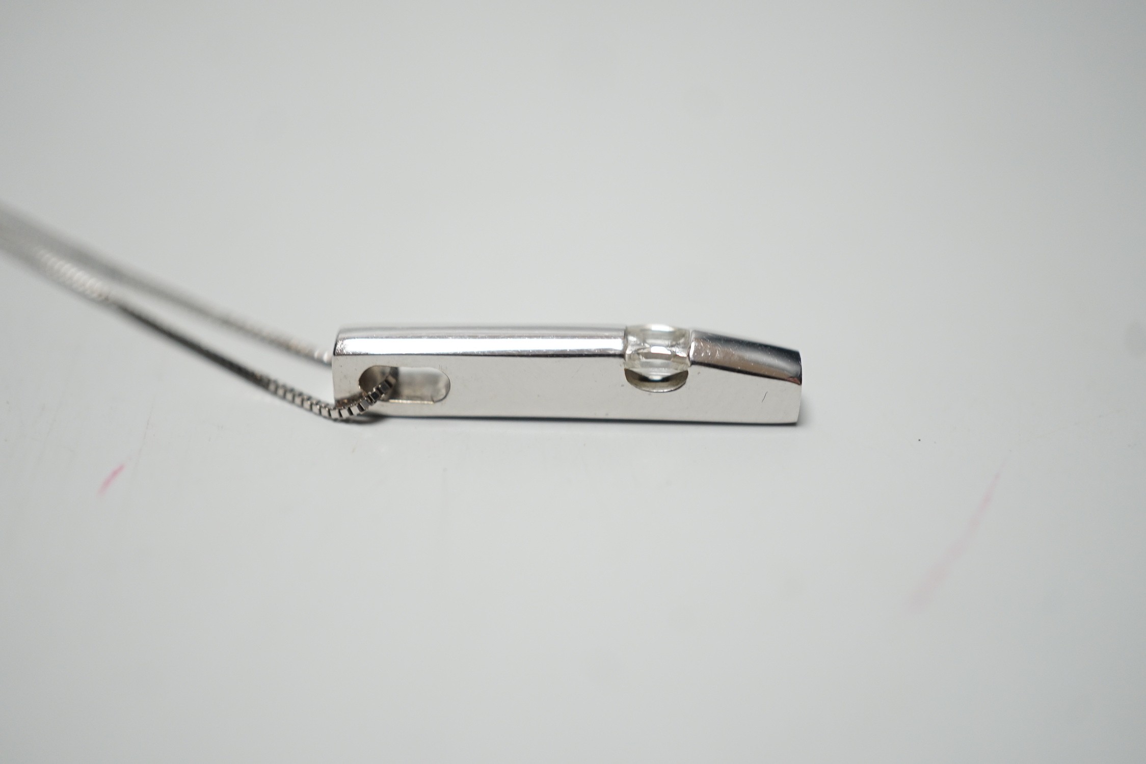 A modern 18ct white gold and solitaire diamond set pendant, 22mm, on an 18ct white gold fine link chain, 46cm, gross weight 4.1 grams.